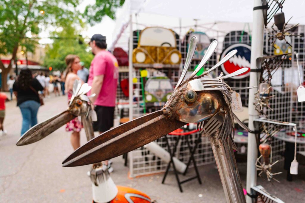 Close up of found art of a blue heron made of forks at an arts festival in Augusta GA