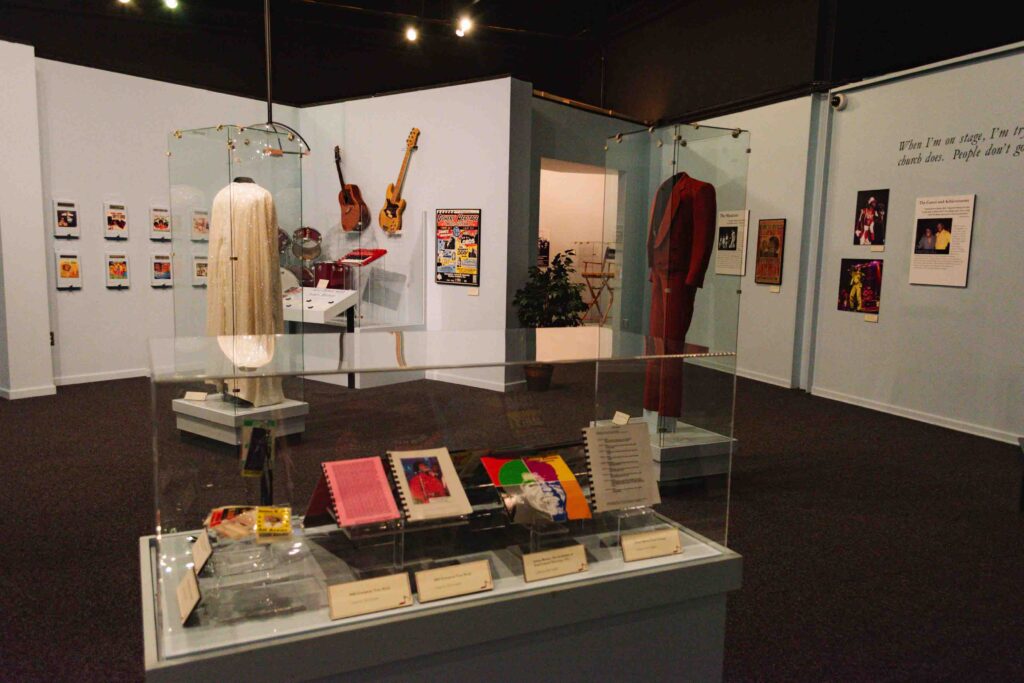 James Brown exhibit in the Augusta History Museum with his outfits, records, and instruments on display.