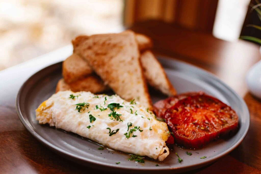 Heirloom Room breakfast of egg white omelet with summer vegetables, grilled tomatoes, and multi grain toast on the side
