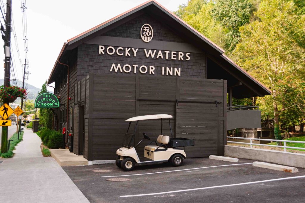 Side view of Rocky Waters Inn with small parking lot for the restaurant on site