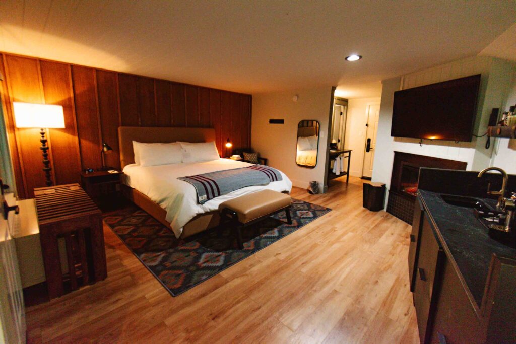 Interior of adults only hotel room in Gatlinburg Tennessee along the Parkway with king size bed, fireplace, mini bar, and soaking tub.