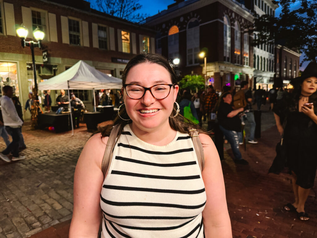 Happy woman on her day trip to Salem at twilight