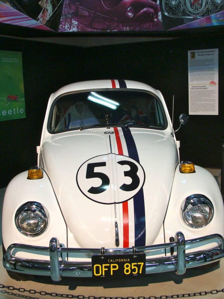 Vertical view of Herbie bug car (a white Volkswagen Bug with the number 53 on the hood) at the San Diego Automotive Museum