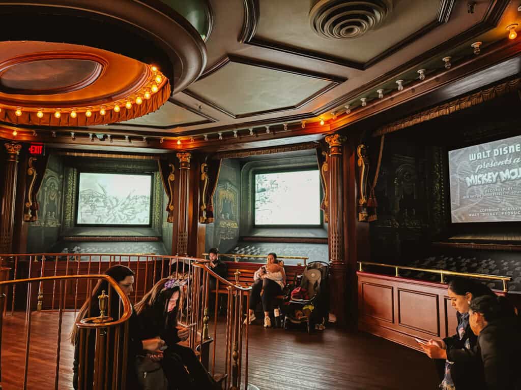 Inside the Main Street Cinema in Disneyland Anaheim with old Mickey cartoons playing on the screens in a circle
