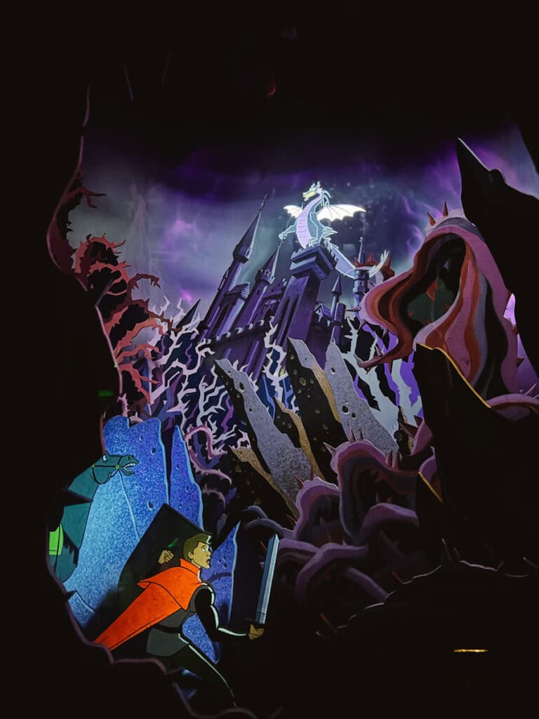 Scene from Sleeping Beauty where Prince Phillip is about to battle Maleficent dragon as seen in the Disneyland Sleeping Beauty Castle walkthrough experience, a great rainy day activity