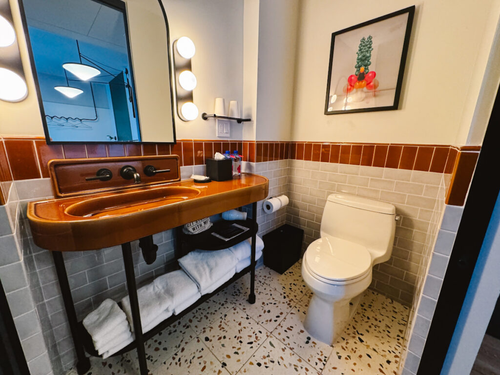 Hotel bathroom view from the side with a small wide sink