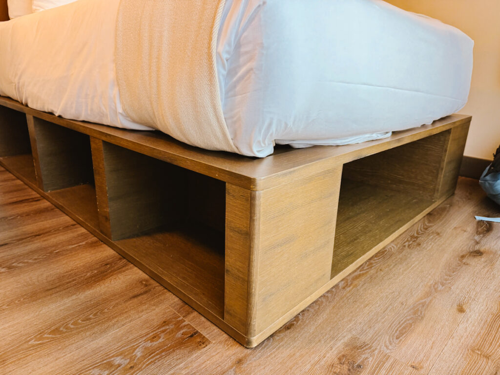 Storage space under a hotel room bed, in a notoriously small room