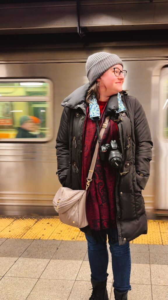 Use the subway in New York, shown here with a woman on the platform in front, to get around