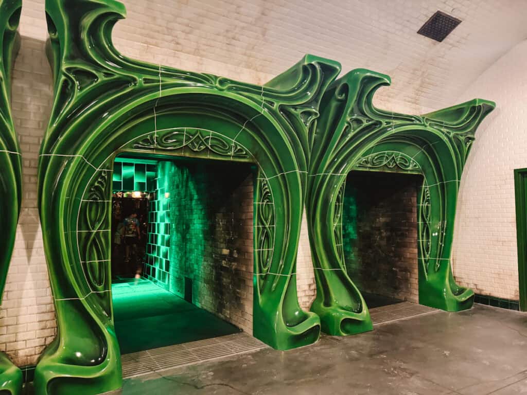 Two floo network green tiled fireplaces to walk through to get to Battle at the Ministry ride in theme park