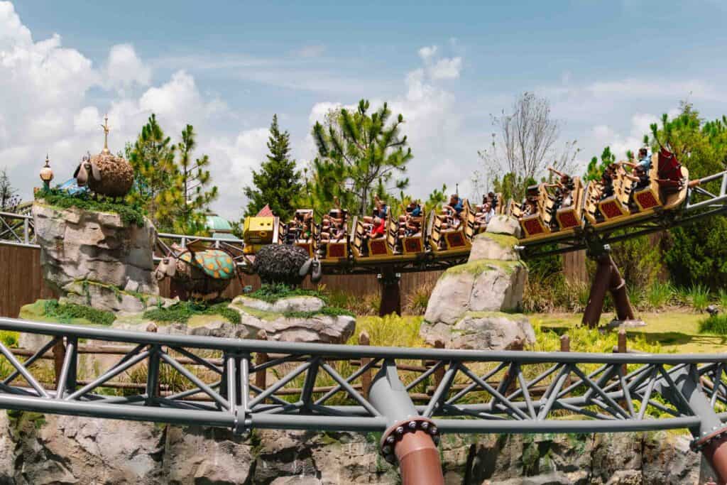 Hiccup's Wing Gliders ride as it goes around a curve with How to Train Your Dragon sheep in the center of the curve