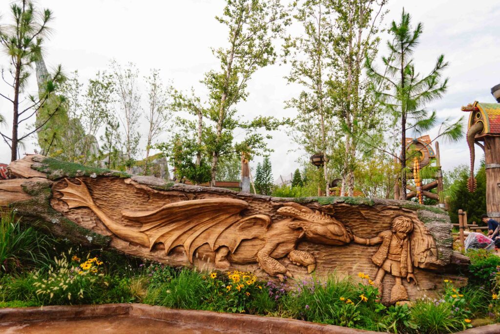 Carved tree trunk of Hiccup touching Toothless for the first time as seen in How to Train Your Dragon