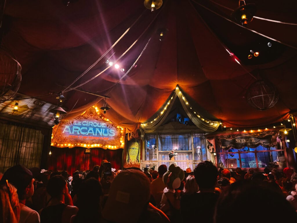 Interior of Le Cirque Arcanus preshow area where the audience is standing waiting to be let into the main theater