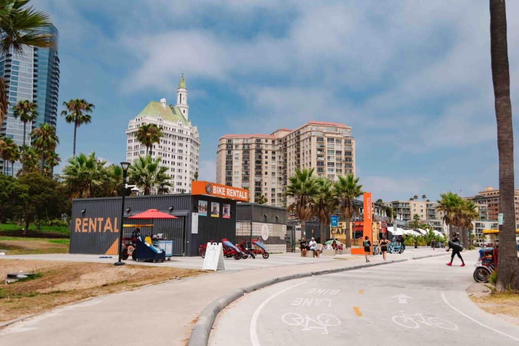 Alamitos Beach pedestrian path with bike rentals to the left and the beach to the right