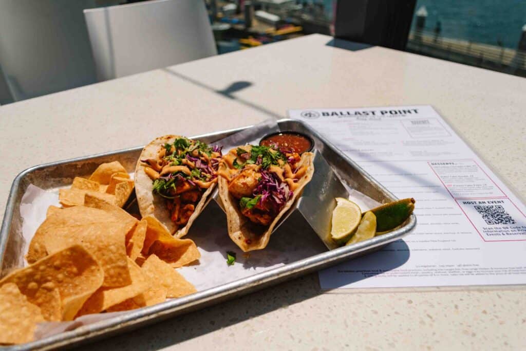 metal tray with two cauliflower tacos and chips, salsa, and lime