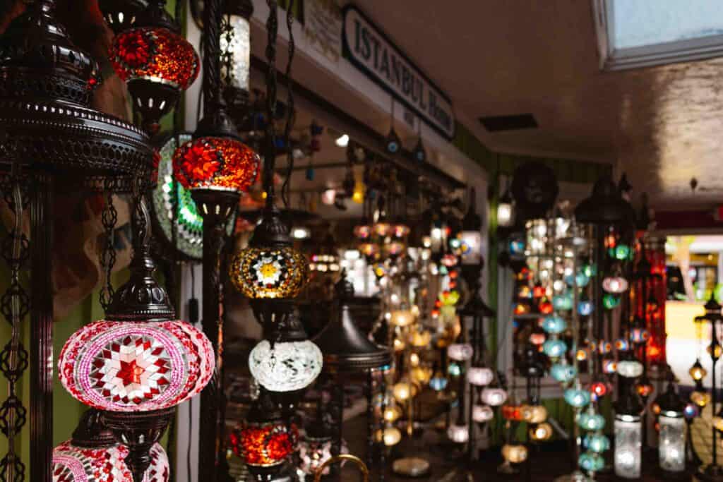 Close up of a Turkish lamp with a bunch of other lamps behind as part of a store front