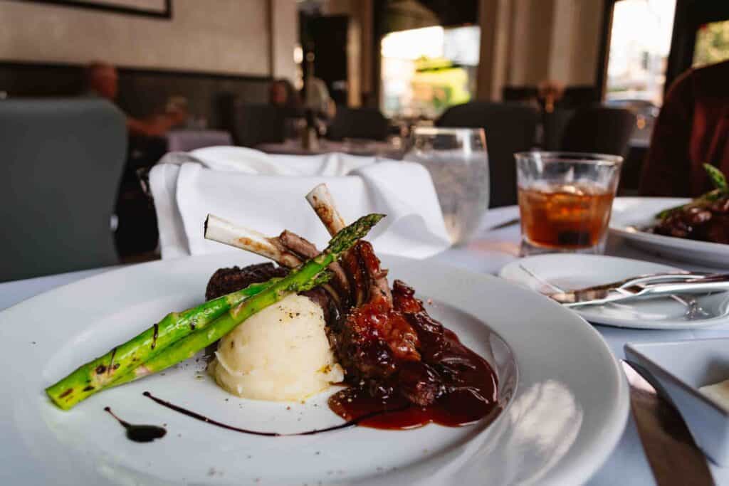 Fine dining plated food of lamb, mashed potatoes, and asparagus