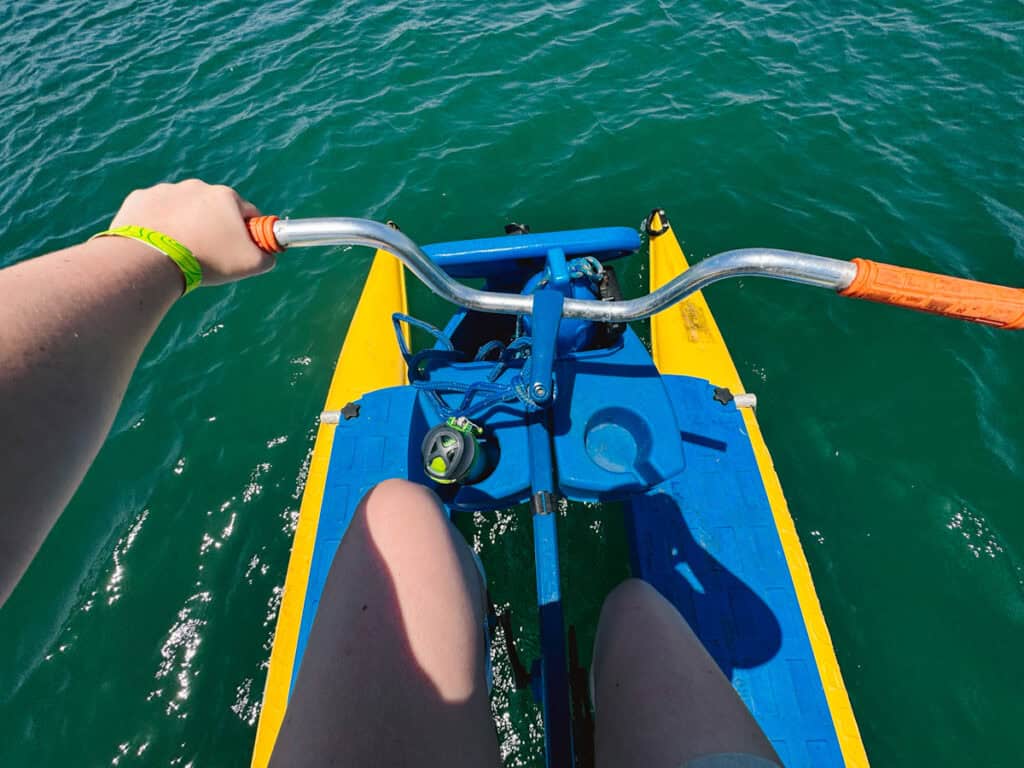 View looking down at a blue and yellow water bike, a fun activity in Long Beach