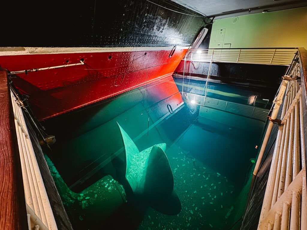 Inside of the Propeller Room at the Queen Mary where you can look down into a pool of water where the propeller sits