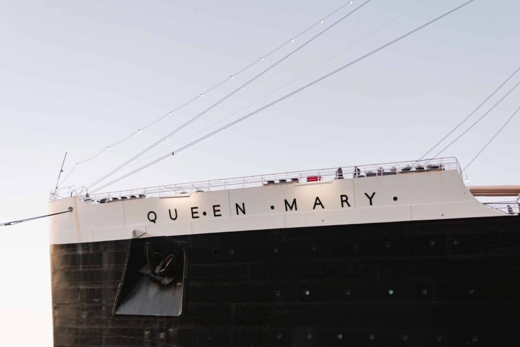 Queen Mary lettering on the side of the ship on white stripe over the black hull
