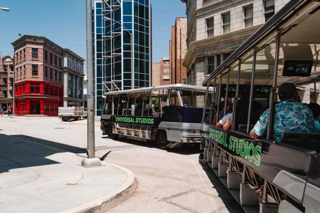 Universal Studios tram tour of the backlot with a tram going around a curve in a New York set