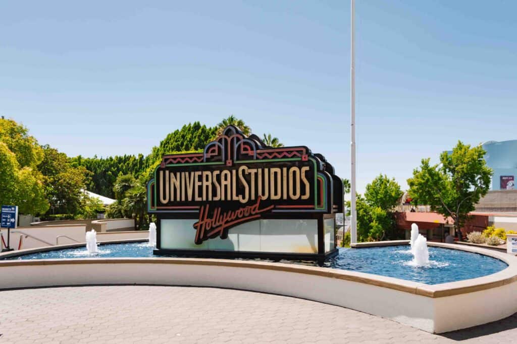 Fountain outside Universal Studios Hollywood with a sign that has the theme park name on it