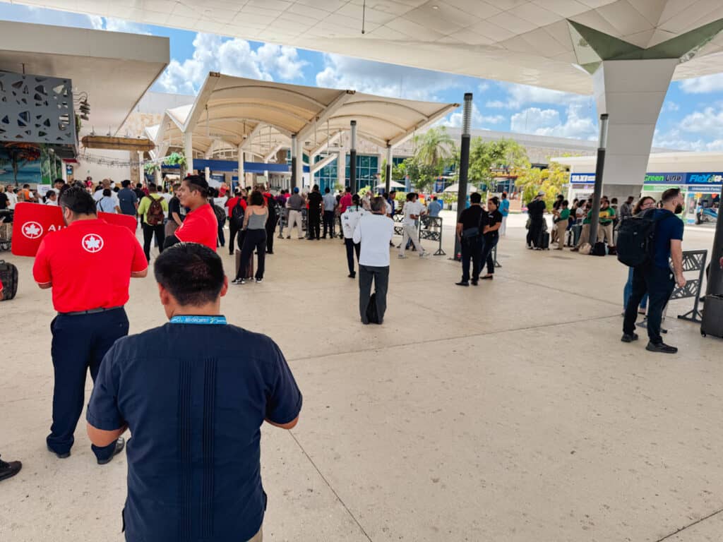 Outside the Cancun Airport where there are lots of people for transfers, time share reps, and scammers