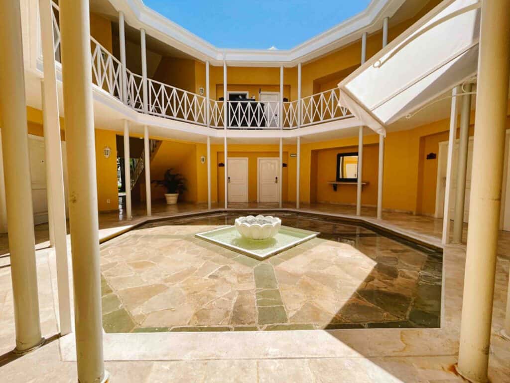 Rounded building with an open courtyard in the center where hotel rooms are on the edges fanning out