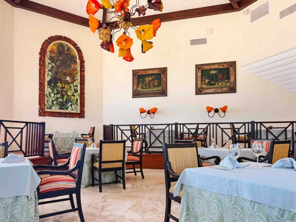 Spices interior of restaurant with high ceilings and glass flower chandelier