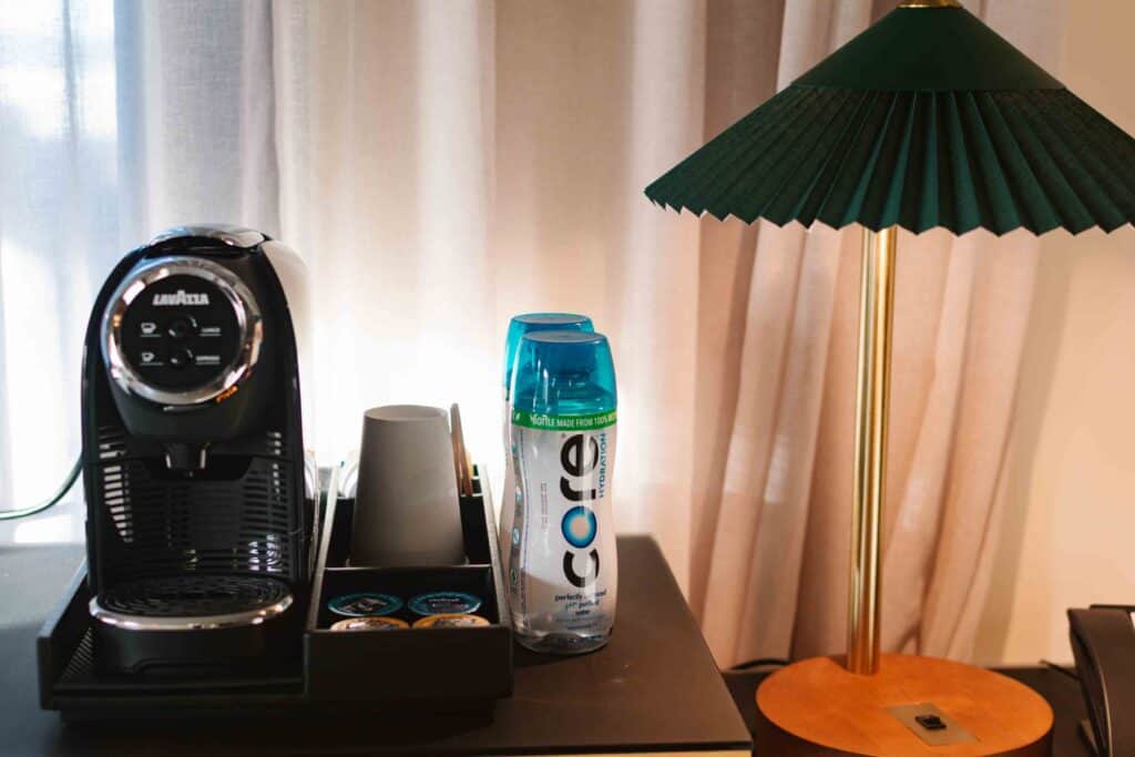 The Waymark Hotel room amenities include Lavazza coffee maker shown here and CORE water bottles