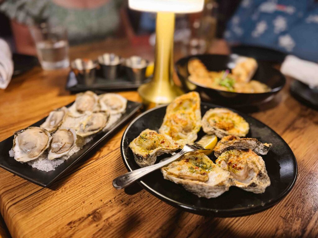 Various oyster appetizers for a group dinner at a steakhouse and seafood restaurant in Gulf Shores Alabama