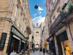 One of the best shopping streets is Rue St James in Bordeaux, shown here with La Gross Cloche belltower in the background